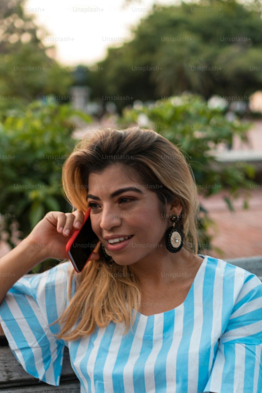 Hispanic young woman talking on mobile phone