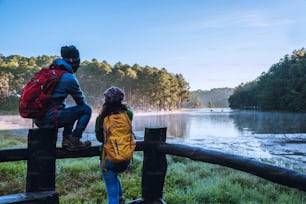 asia couple Pang Ung park travel, take pictures of nature landscape the beautiful at lake, in Thailand.