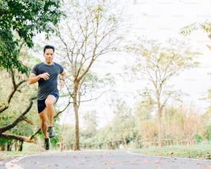 Healthy active Asian man running on track at park in morning .Healthy lifestyle