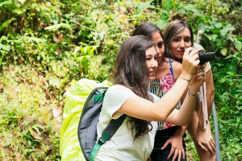 Women Using Camera In Tropical Forest