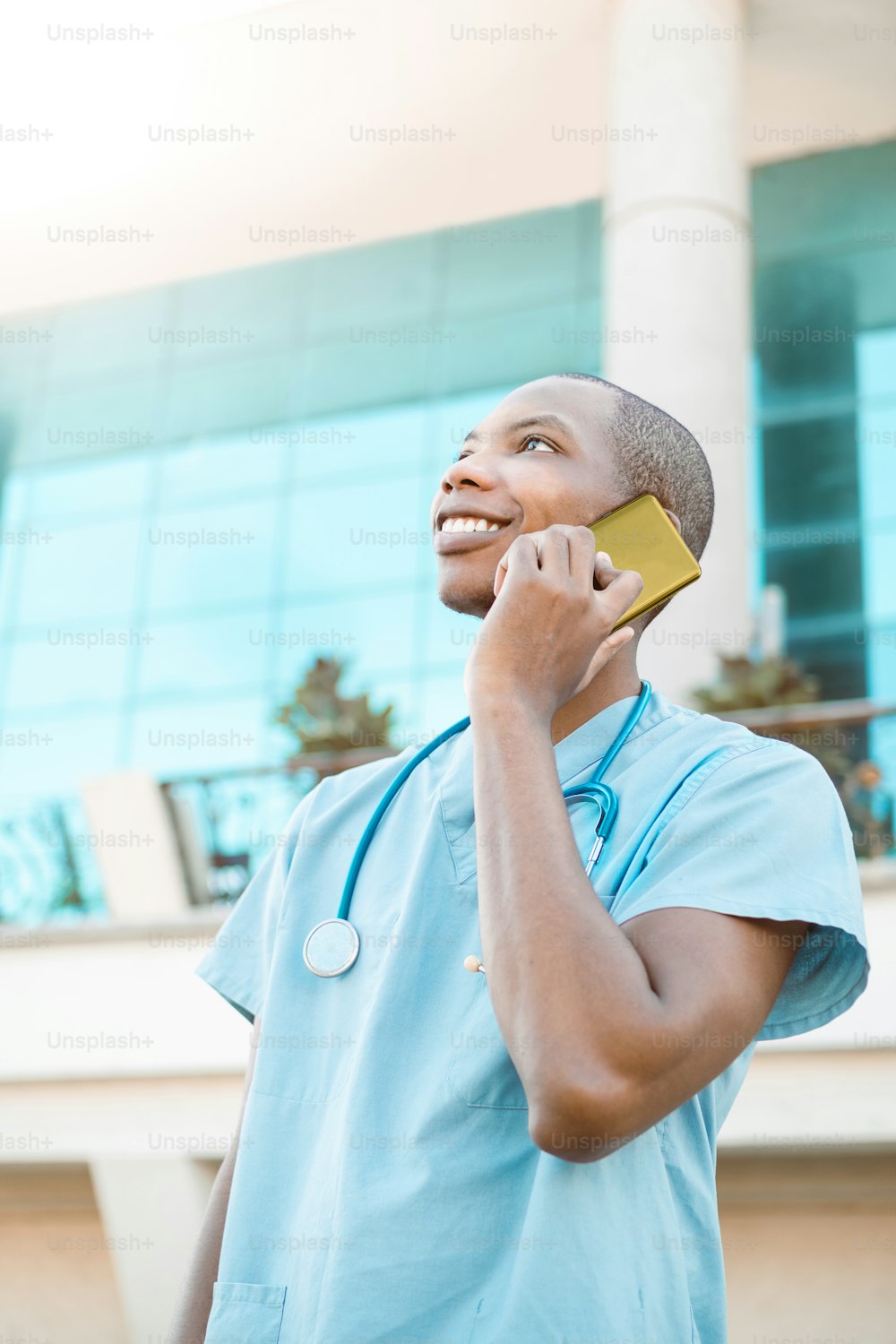 portrait of a cheerful and smiling young african american medical student making a call on a phone. communication concept. with copy space.