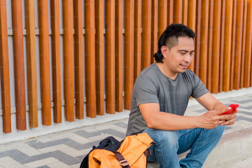 Young Indigenous Hispanic Man Using Mobile Phone Outdoors