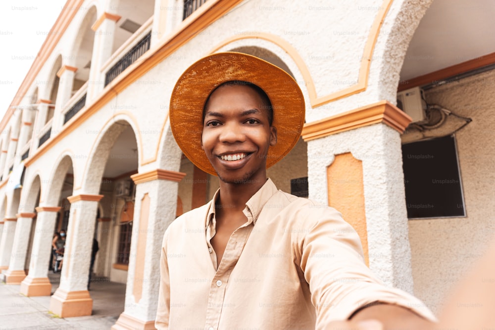Happy young man millennial taking a selfie smiling at the camera near colonial city of honduras.