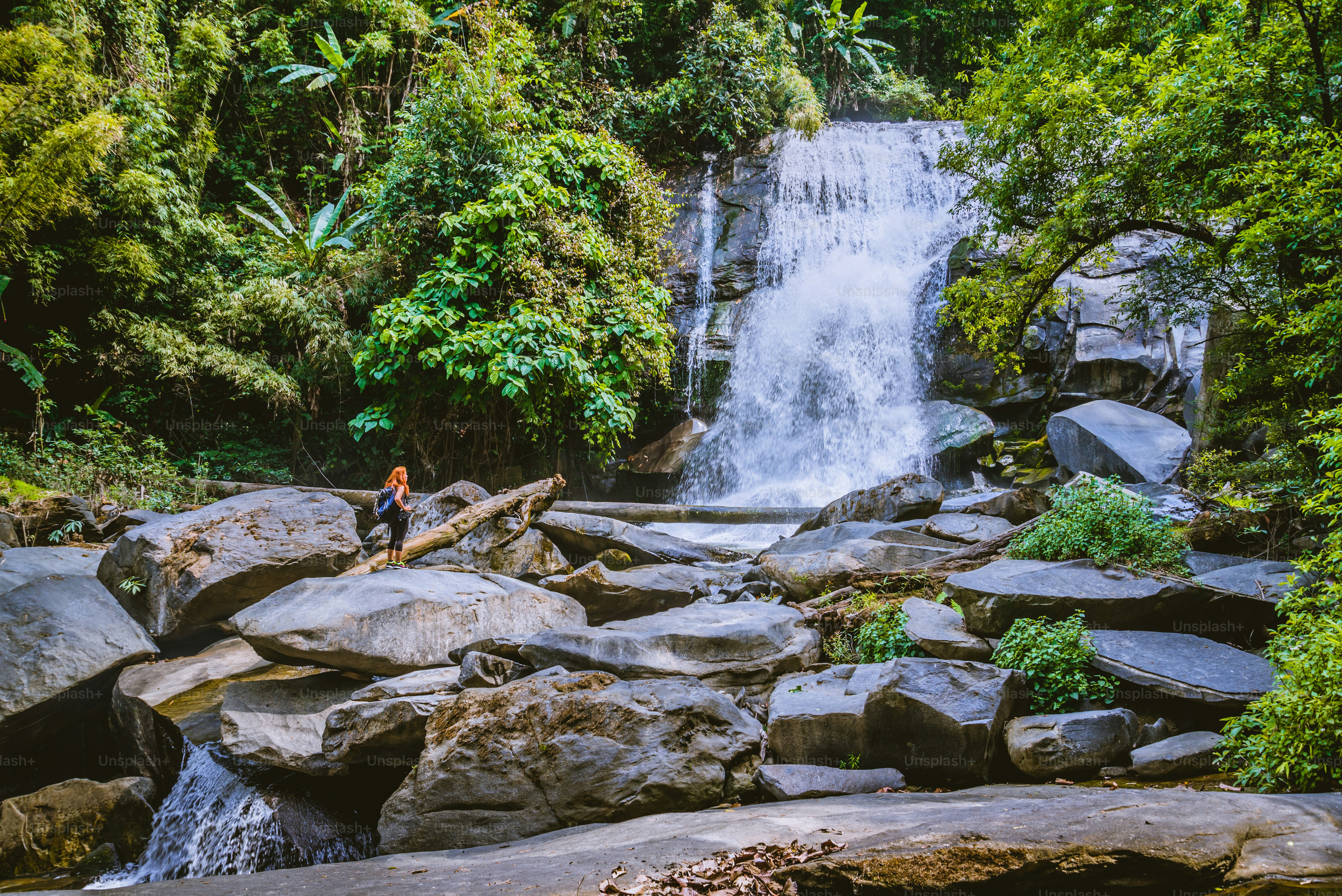 Women travel. woman asia travelers travel nature Forests, mountains, waterfalls. Travel Siliphum Waterfall at Chiangmai, in  Thailand.