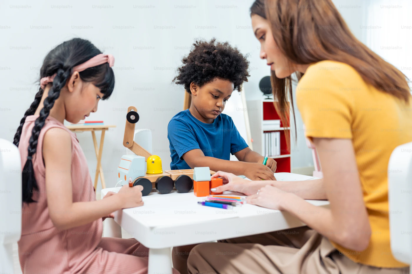 A family counselor working with two children in family therapy