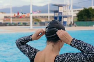 Woman wearing goggles preparing to swim