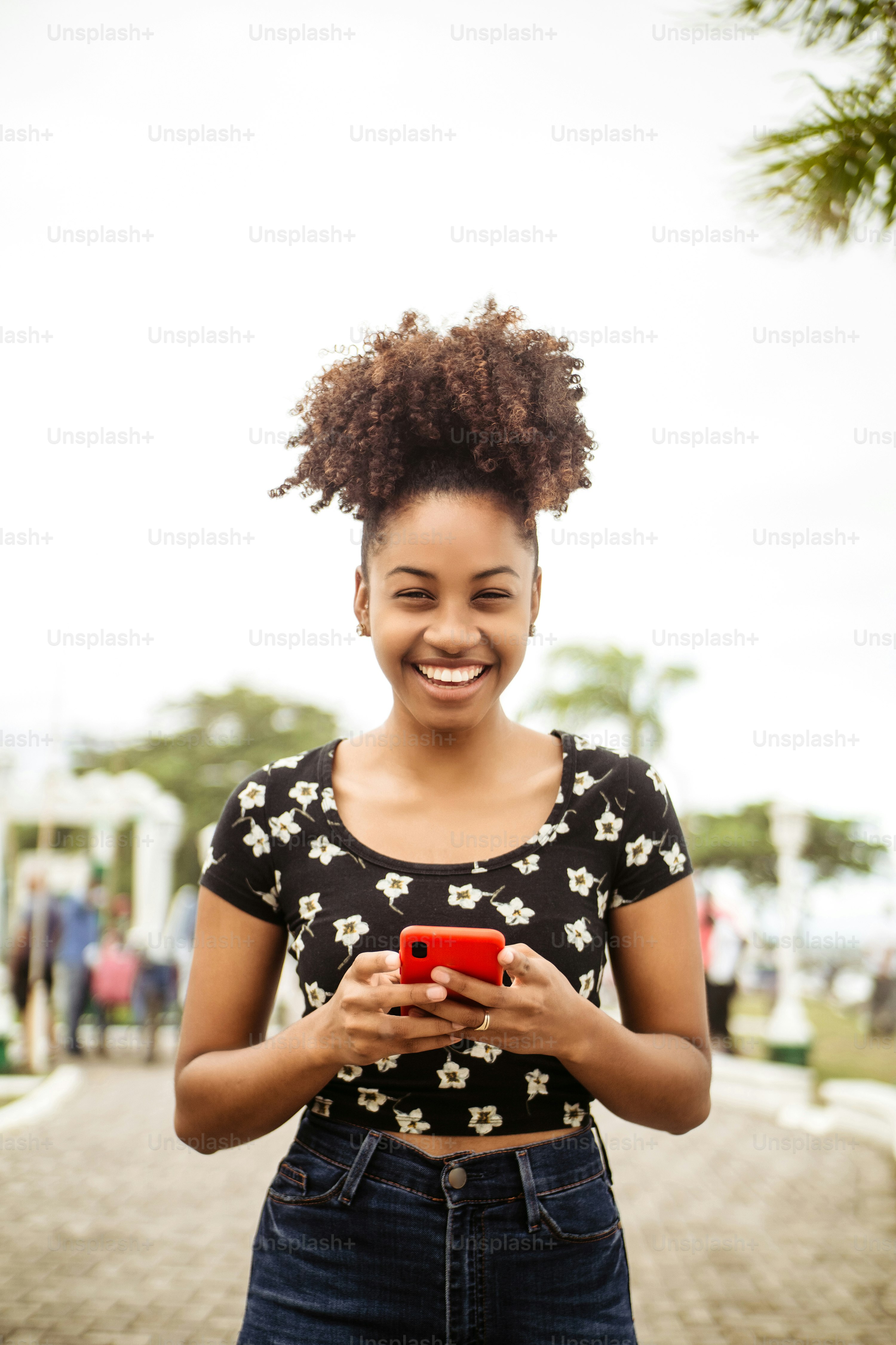 Person holding a smartphone outdoors in a rural landscape with no visible cell towers