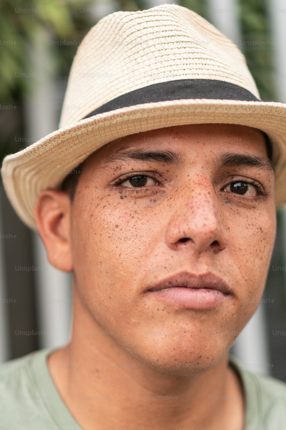 Freckled man wearing a hat on the street