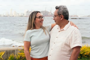 Latin couple in their 50s standing in a park