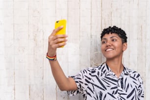 Latin woman taking selfie on sunny day