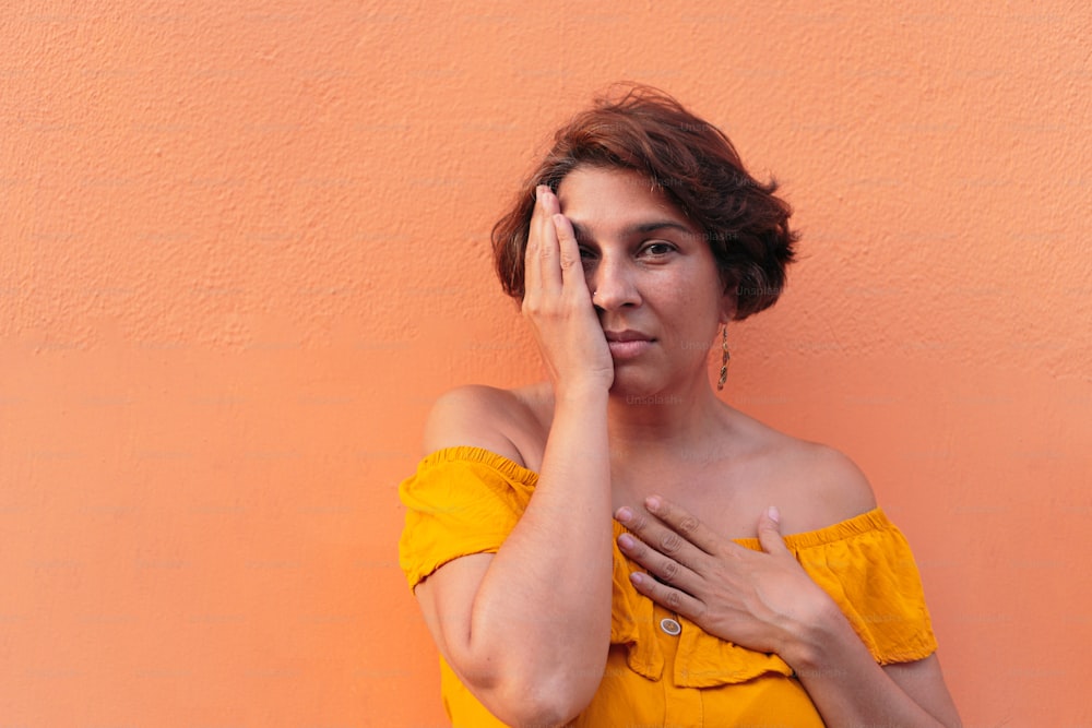 Latin woman with colorful orange background.