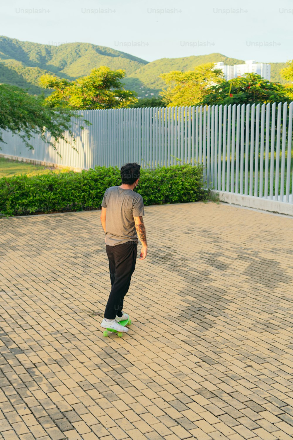 Young man arriving at college on a skateboard