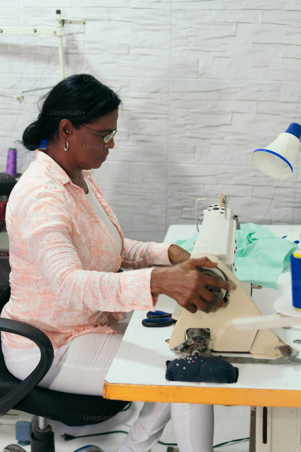 African dressmaker creating a new collection of clothing design. Tailoring and sewing. Lifestyle and business occupation