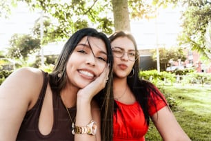 Two young latin woman friends taking a selfie.