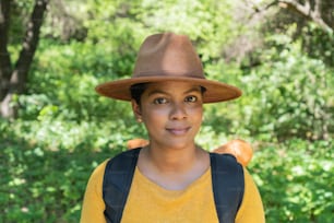 Portrait of an attractive hiker, backpacking, standing outdoors on an autumn day, looking at the camera.
