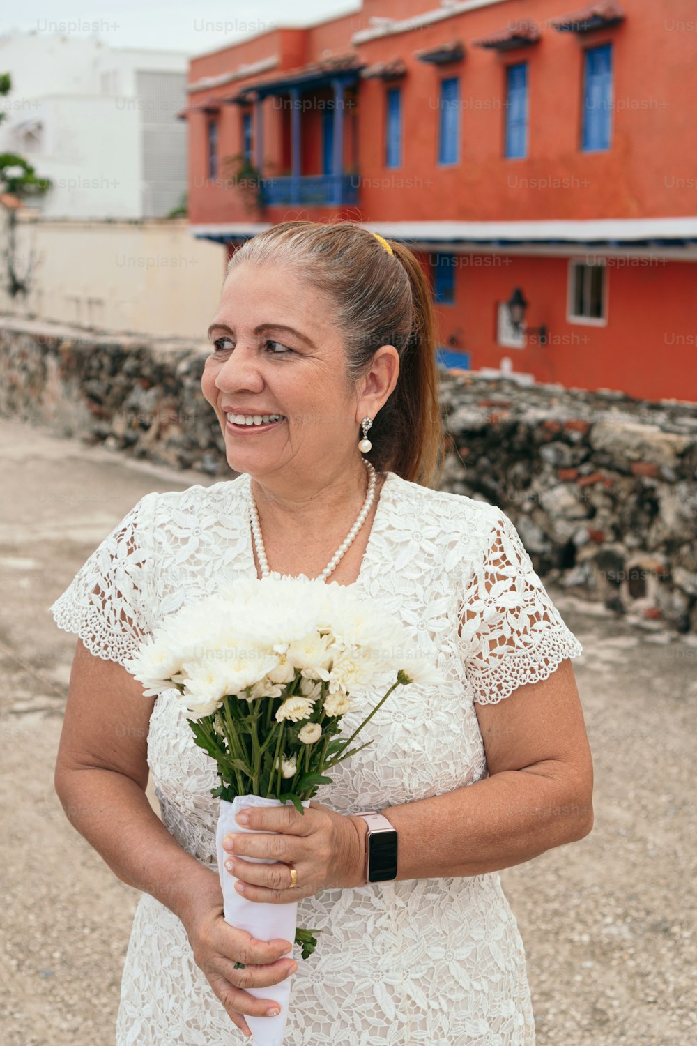 Portrait of bride with a bouquet of flowers in the street