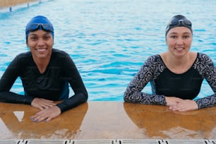 Two swimmers preparing to race at the swimming pool.
