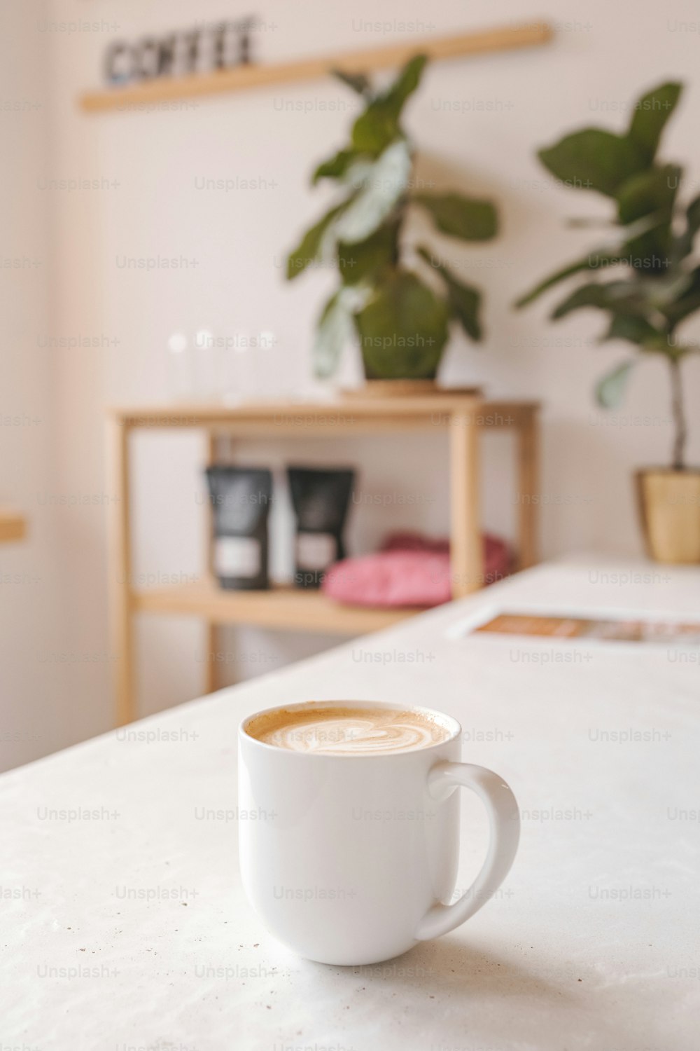 a cup of coffee sitting on top of a table