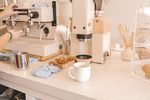 a woman is making a cup of coffee