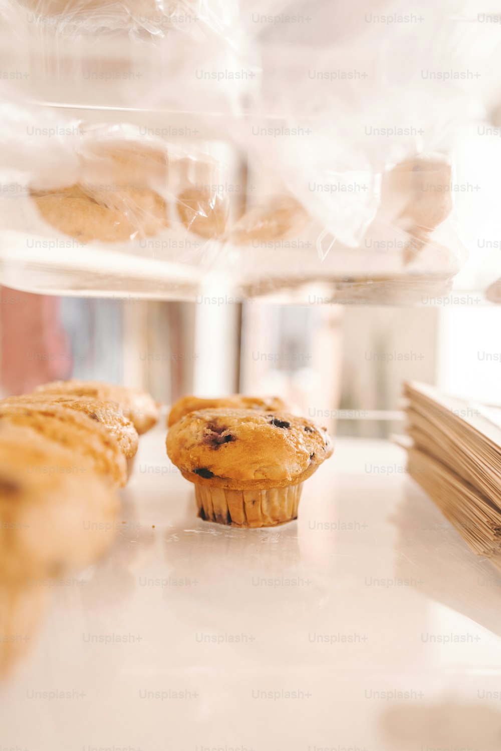 two muffins sitting on a counter in a bakery