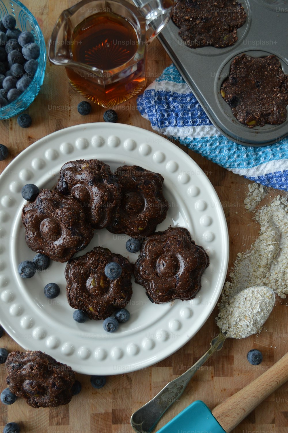 a white plate topped with chocolate cookies and blueberries