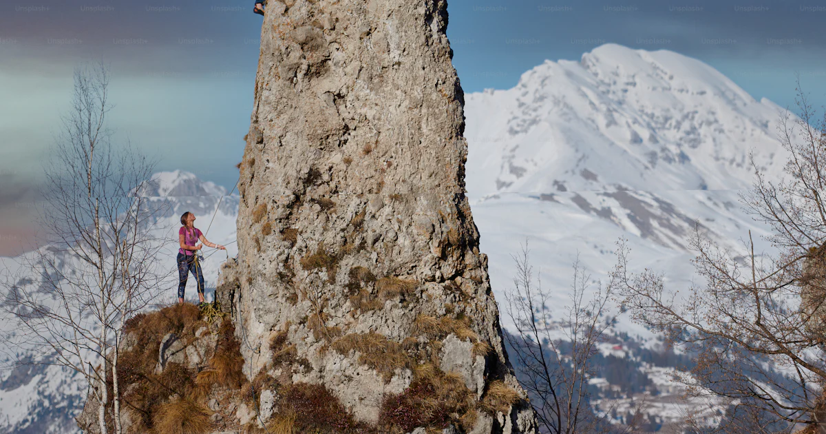 Peak Ropics Rocks Rocky peak with a couple of climbers in ropes photo – Winter Image on ...