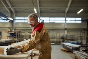 목공 작업장에서 목재 �가구를 만드는 행복한 육체 노동자.