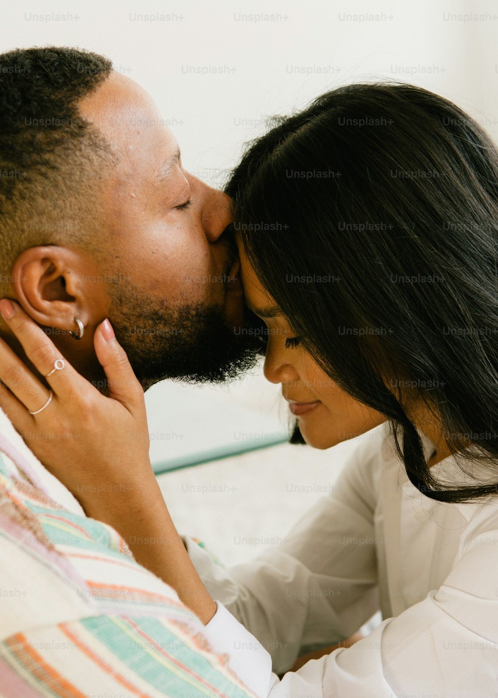 a man kissing a woman on the cheek