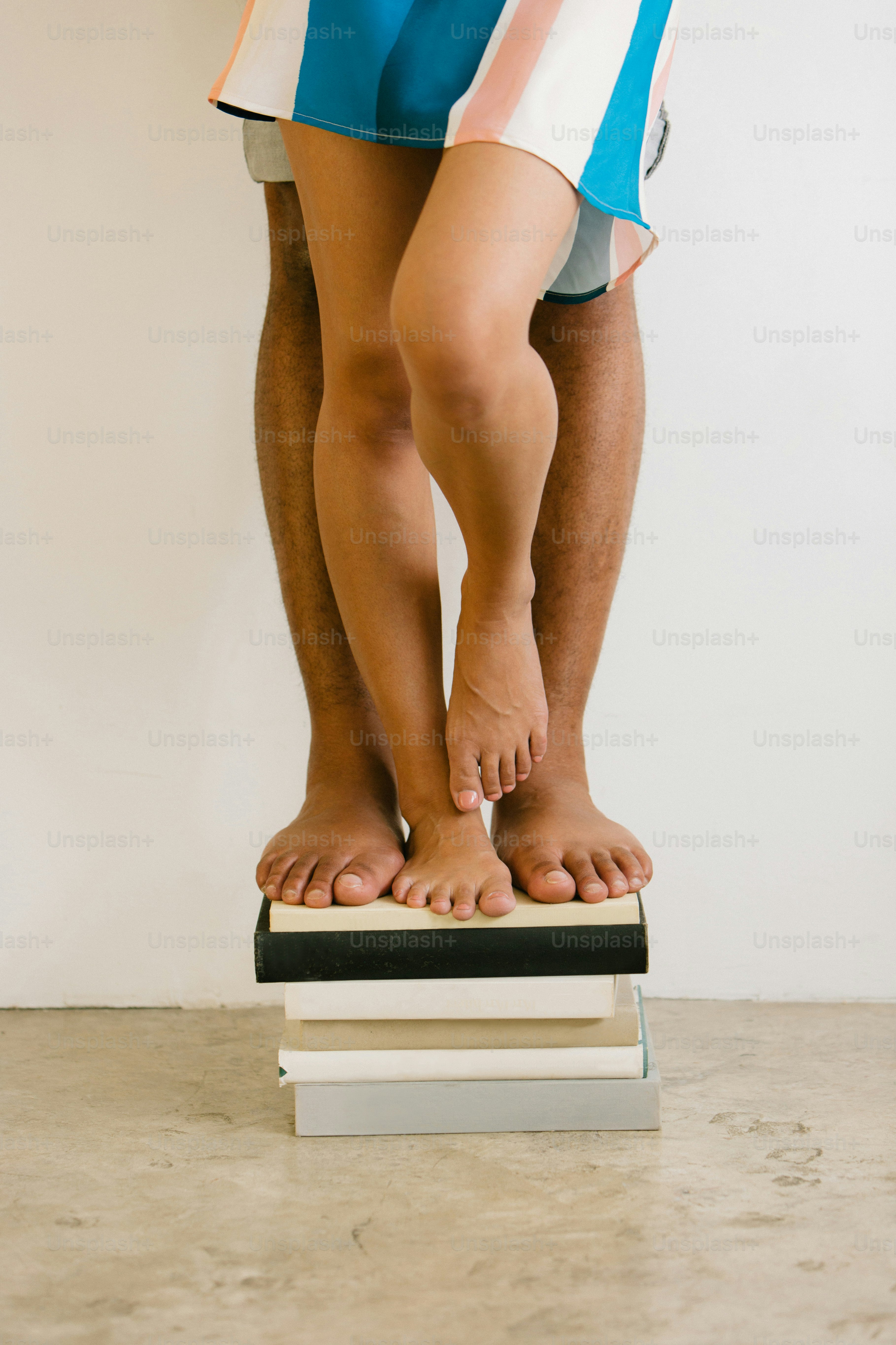 a man standing on top of a stack of books