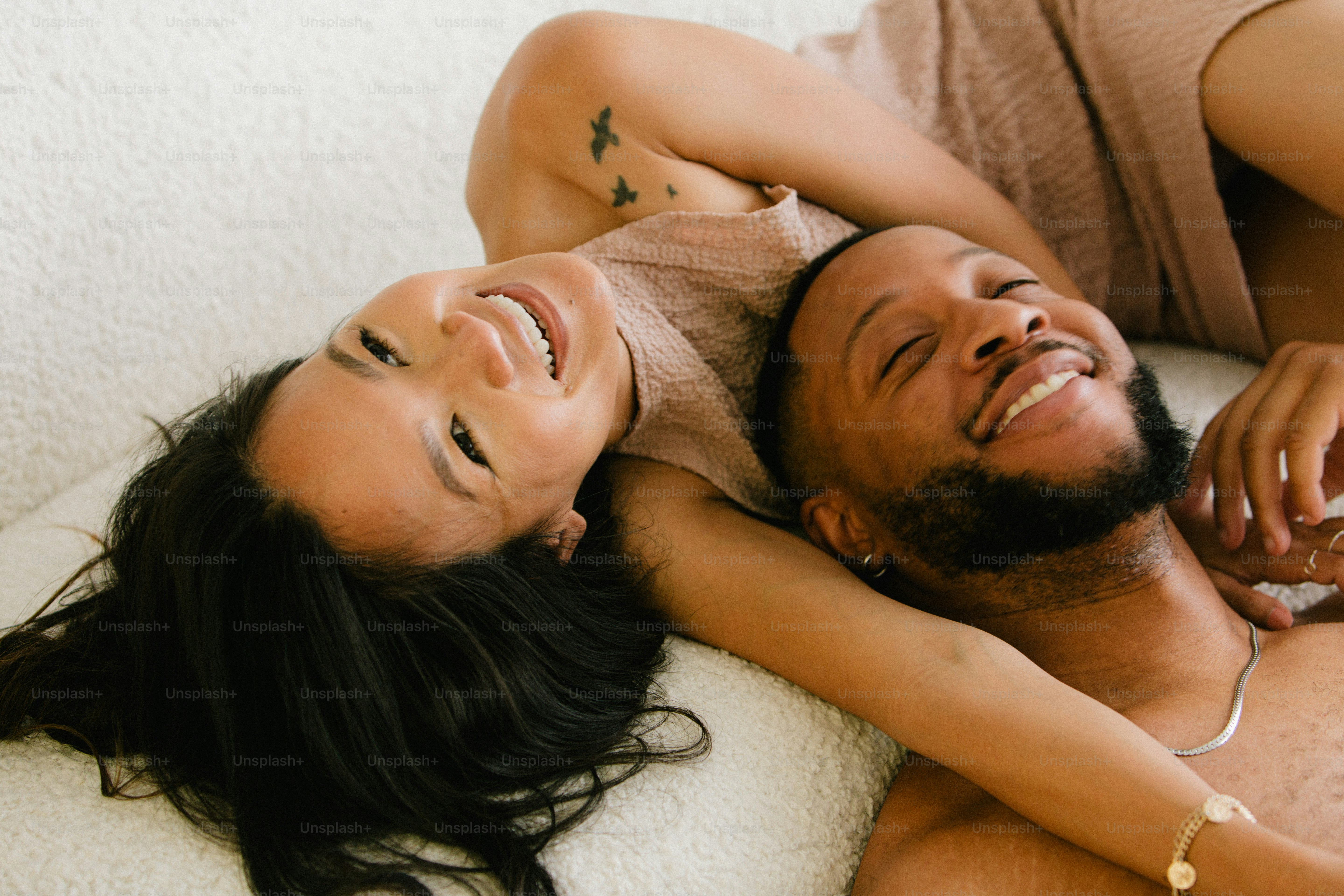 a man and a woman laying on a bed