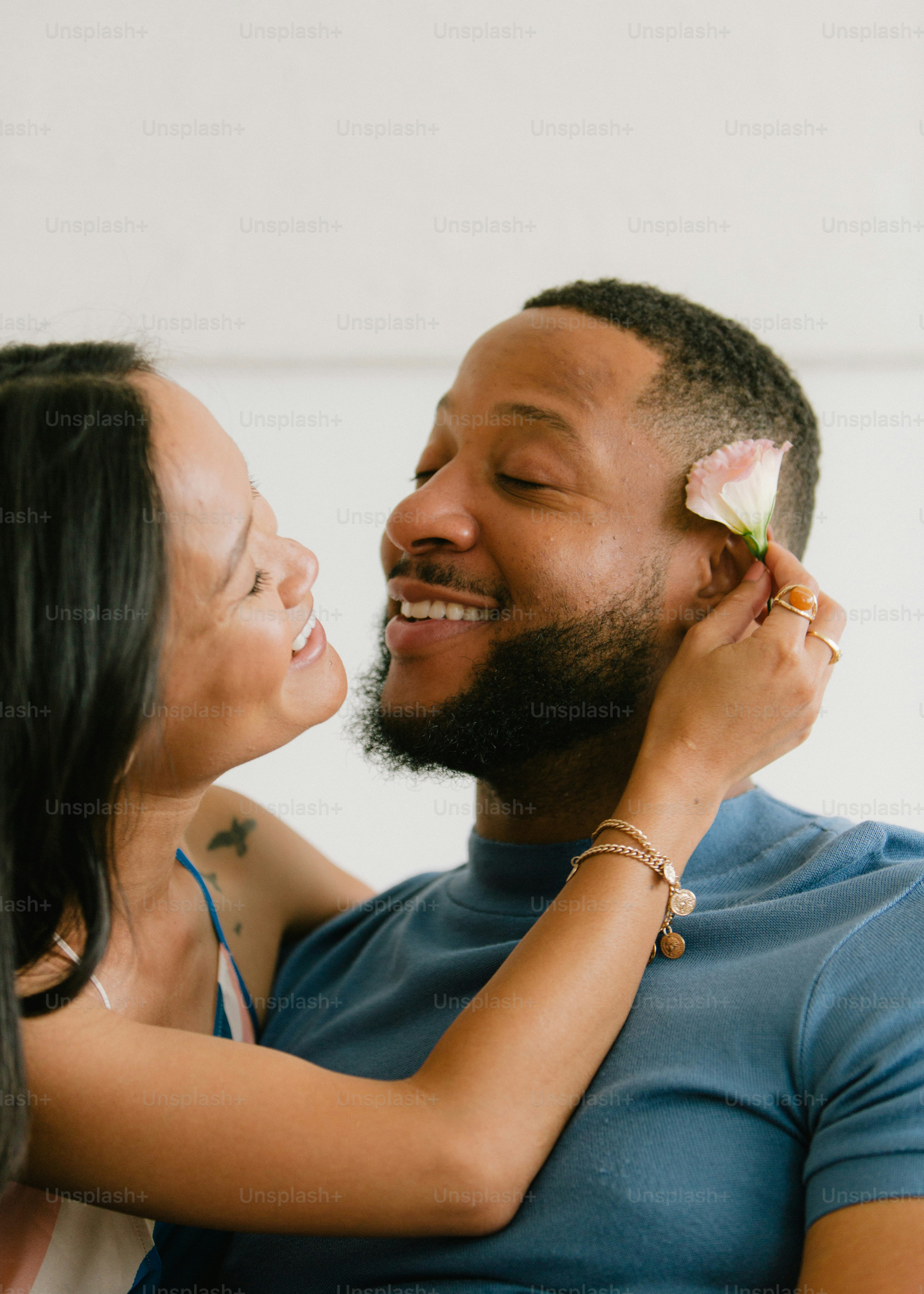 a man and a woman smiling and touching each other