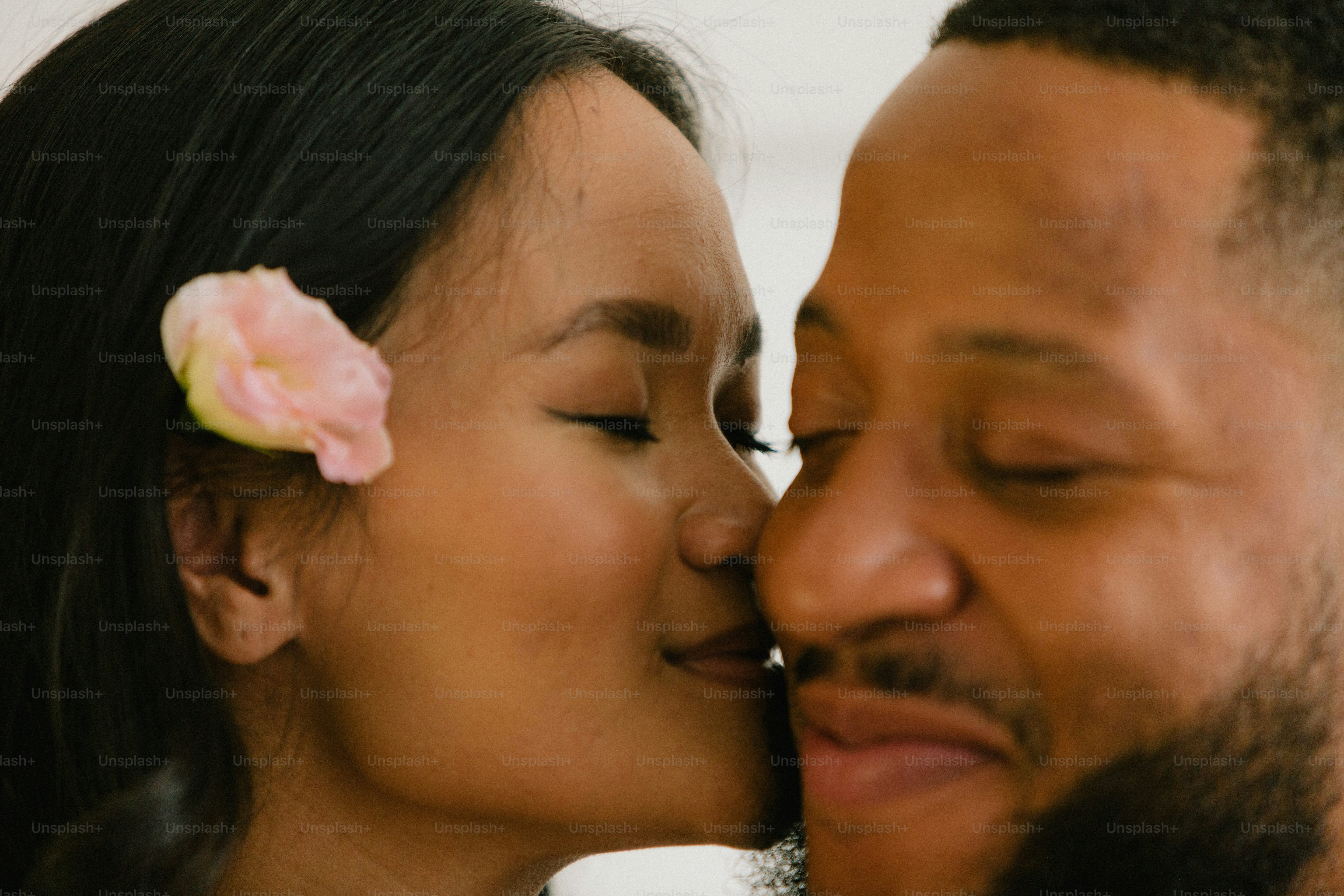 a man and a woman kissing each other