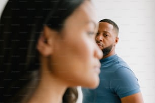 a man and a woman looking in the mirror