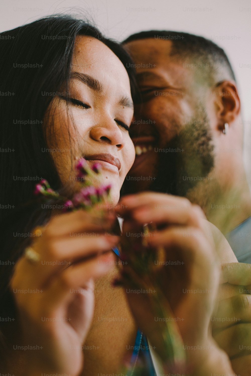 a man and a woman looking at a flower