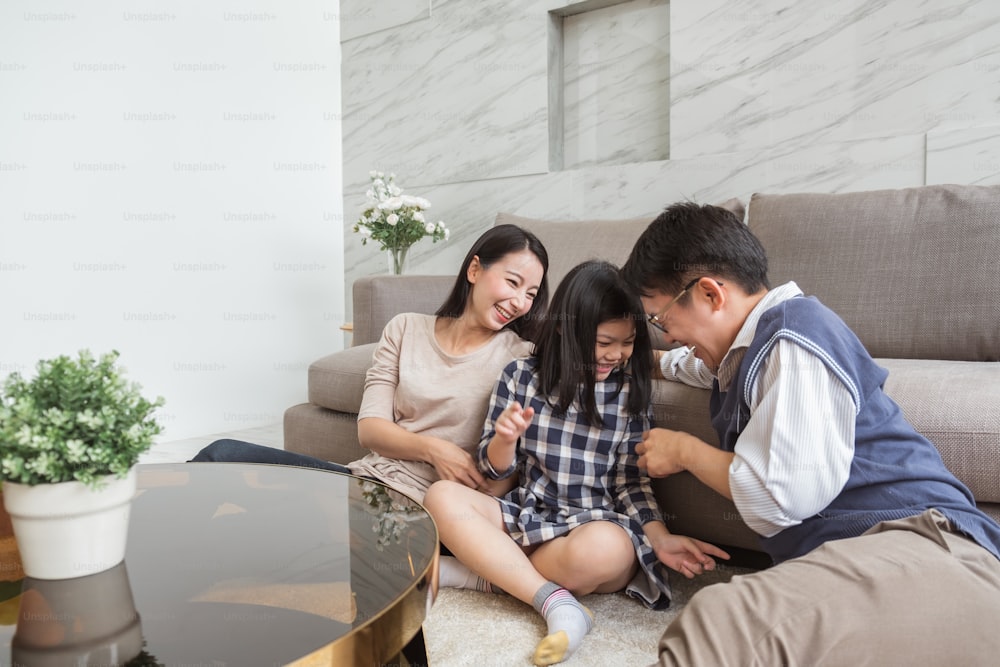 Happy Asian family playing together at home