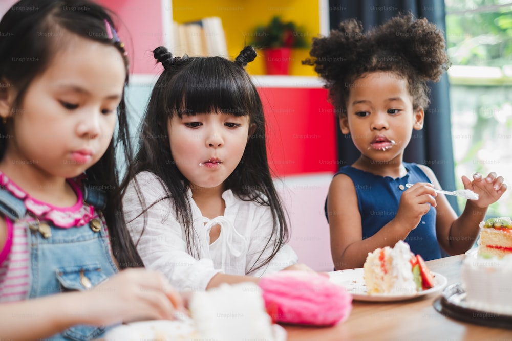 Diversity girl kids eating sweet cake