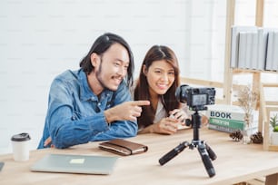 Two of young Asian blogger or vlogger using video online live streaming and broadcasting
