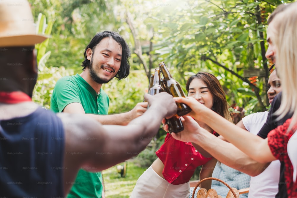 Group of deversity people having barbecue/barbeque party at home, cooking grilled meat/beef for lunch, happy friends party lifestyle concept