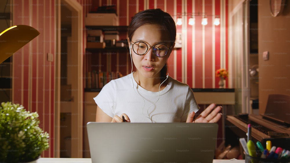 아시아 사업가는 야간 초과 근무, 화상 통화 회의 또는 노트북 컴퓨터에서 가상 회의로 집에서 일합니다.