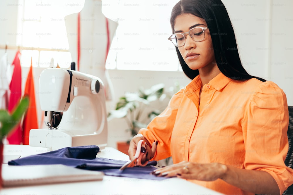 Brazilian woman working in her sewing studio. Entrepreneurial Latin woman.