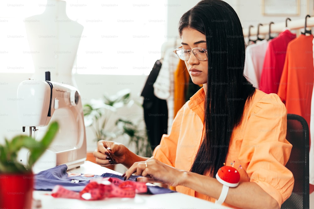 Brazilian woman working in her sewing studio. Entrepreneurial Latin woman.