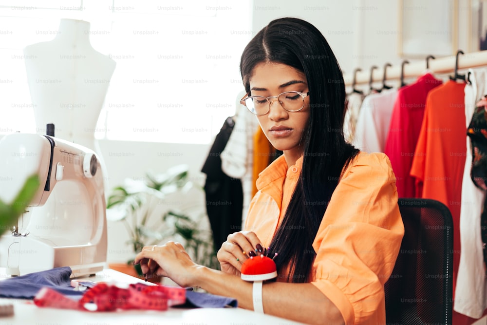 Brazilian woman working in her sewing studio. Entrepreneurial Latin woman.