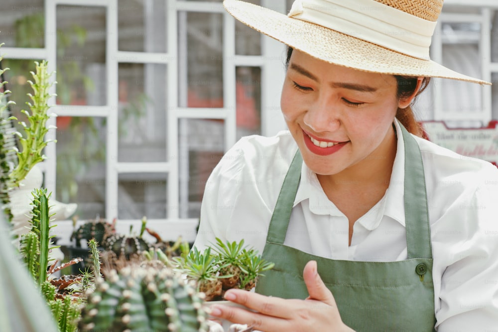 Portrait of Young Asian woman SME small business entrepreneur as cactus plant farm owner smile