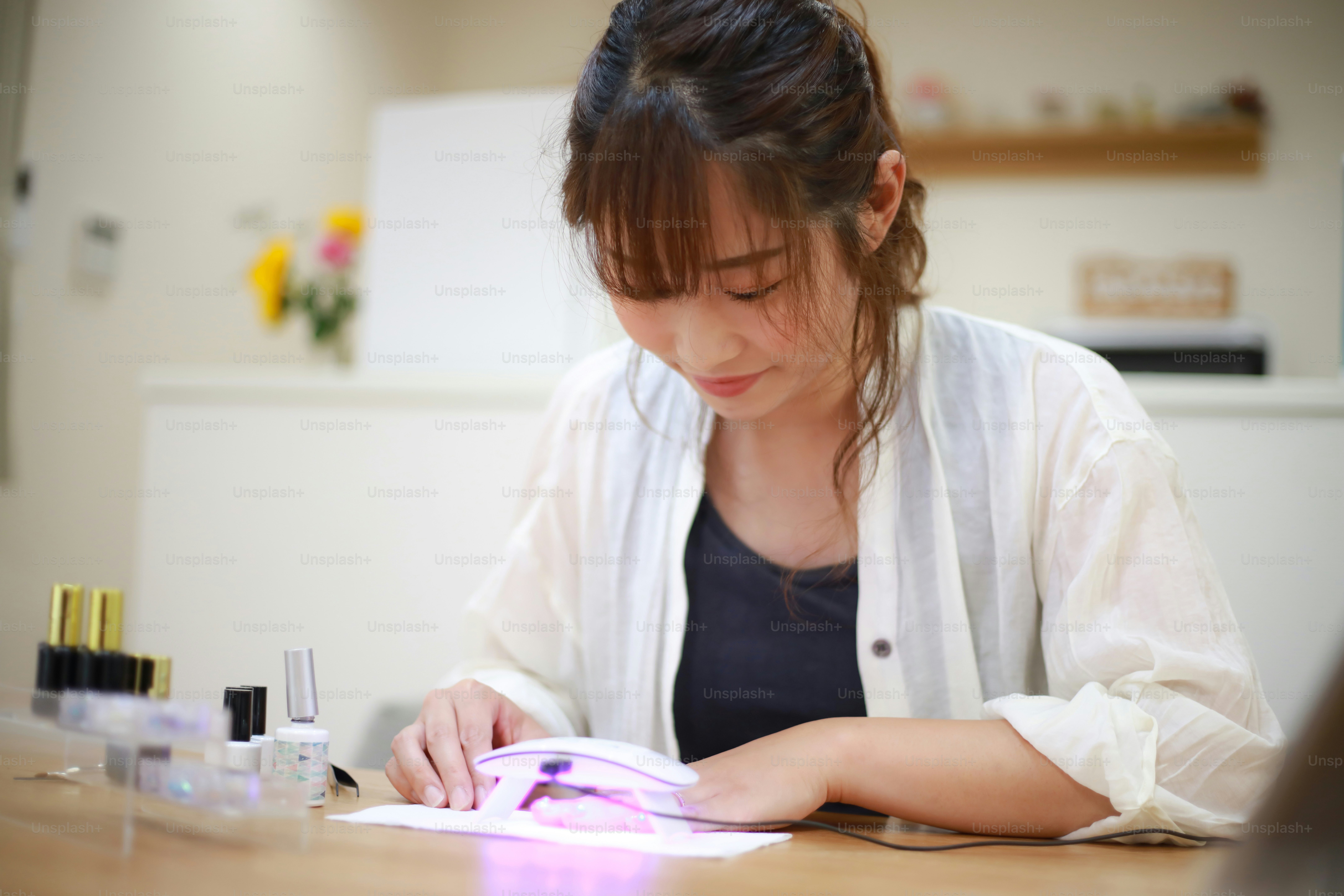 DIY nail artist using quality gel nail products at home manicure station