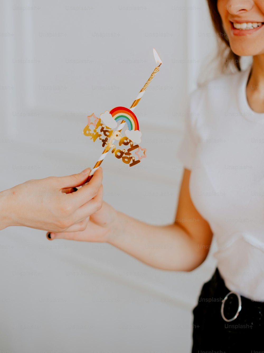 a woman is holding a toy with a rainbow on it