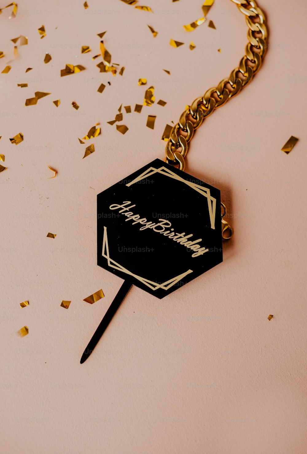 a black and gold keychain with a name tag on it