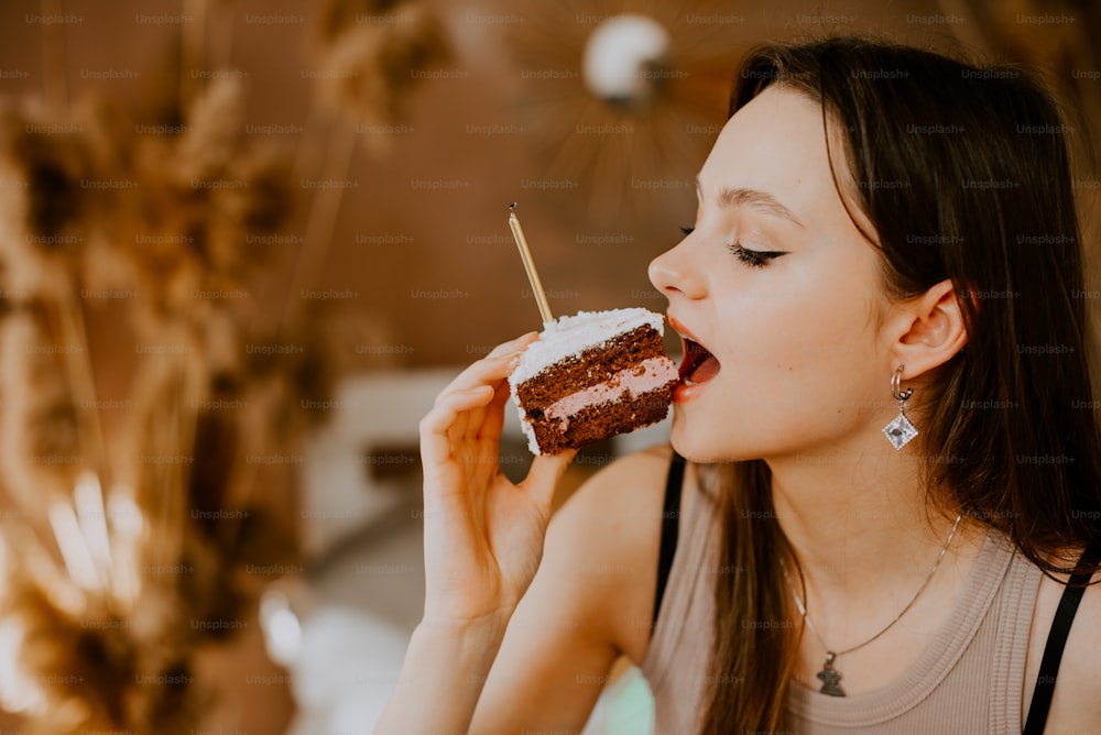 a woman is eating a piece of cake