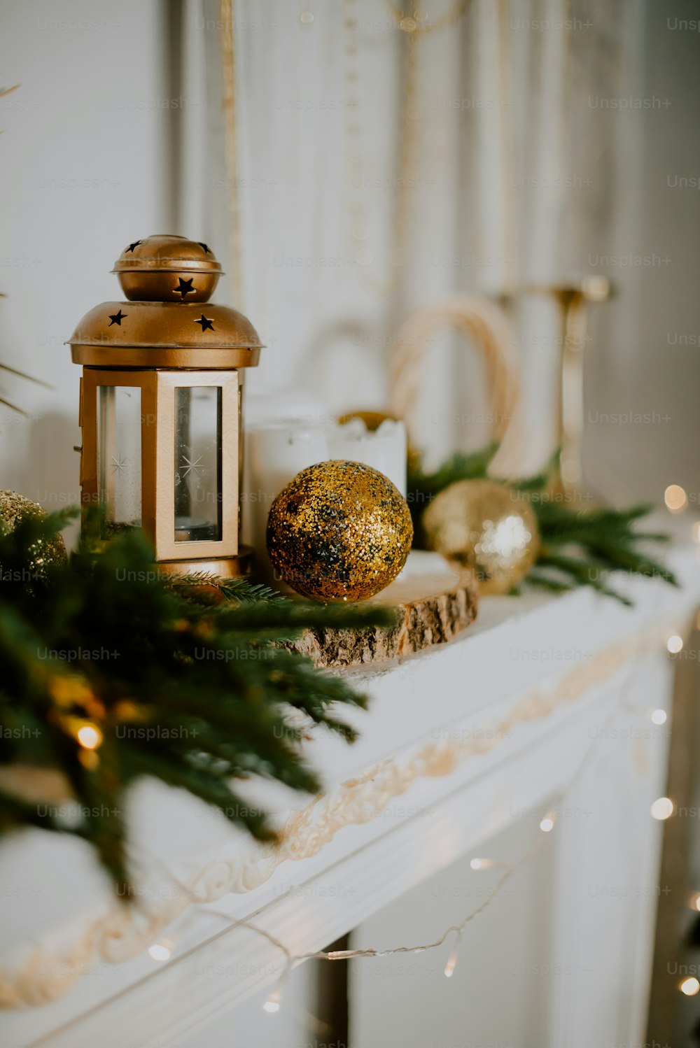 a mantle with a lit candle and ornaments on it