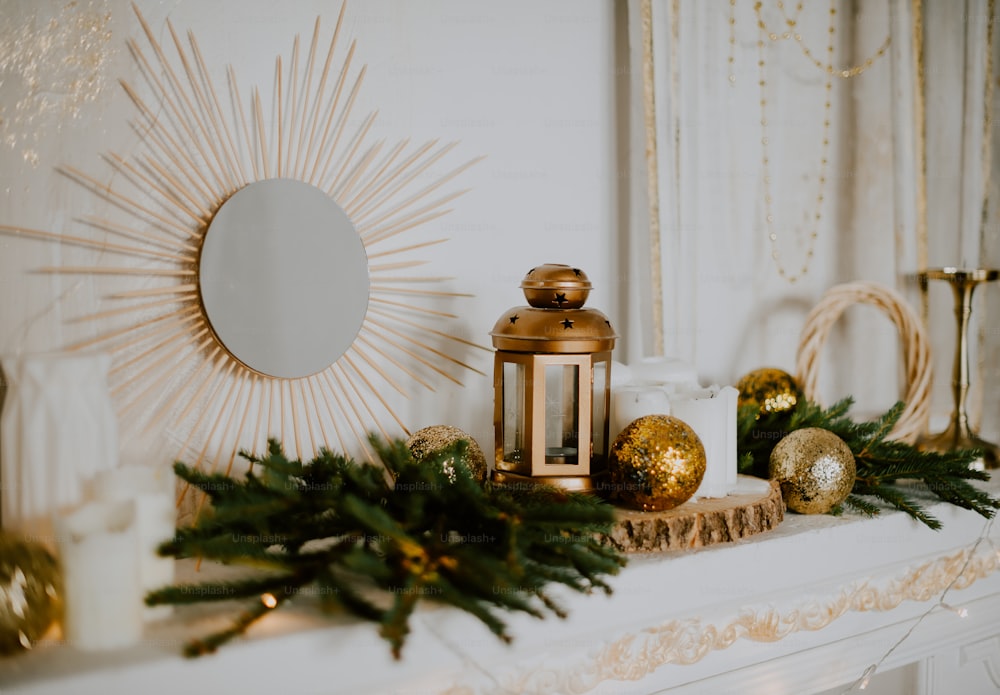 a mantle with a candle, christmas decorations and a mirror