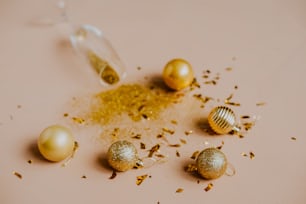 a table topped with gold ornaments and confetti